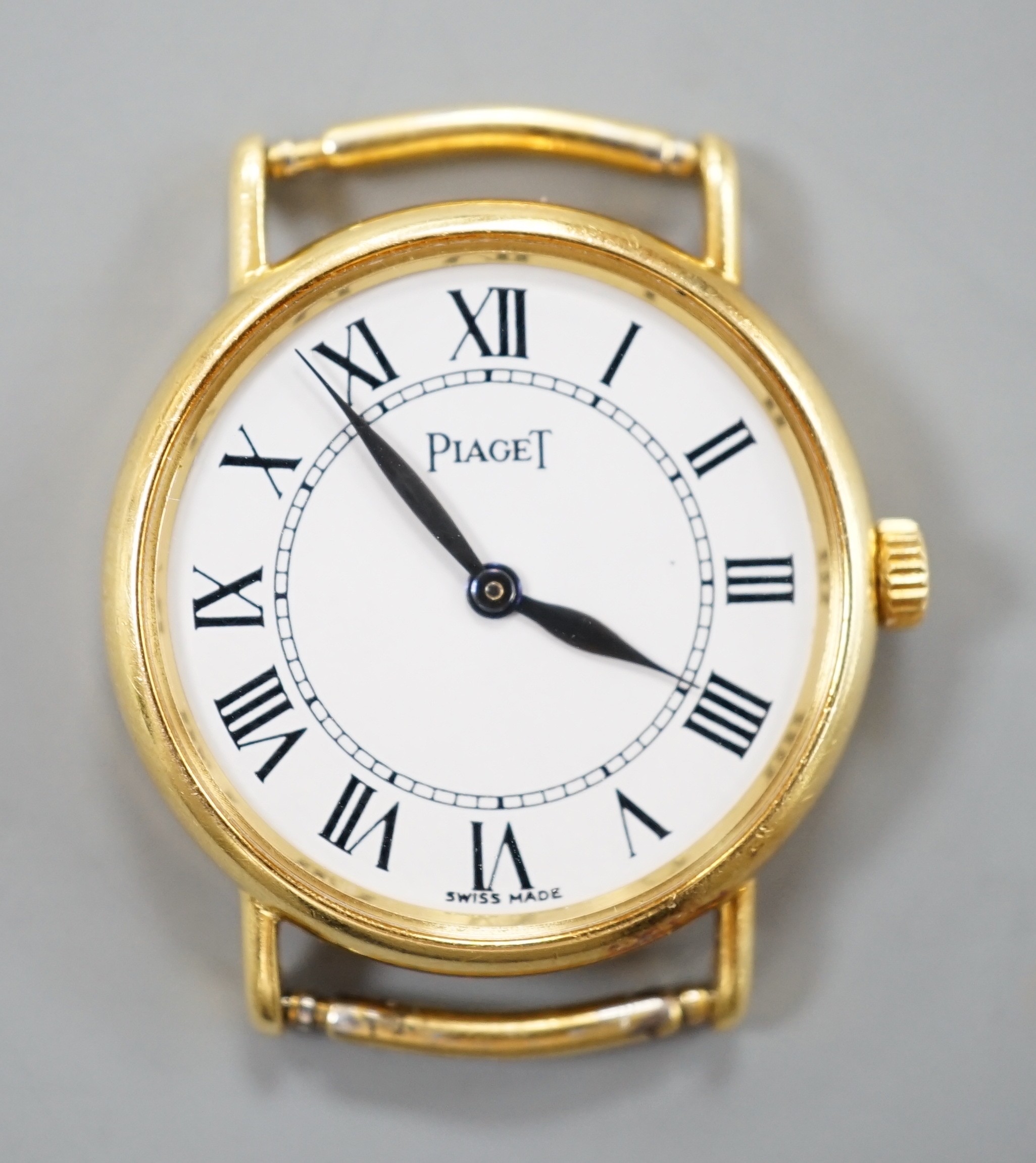 A lady's modern 18ct gold Piaget quartz wrist watch, with Roman dial, no strap, case diameter 23mm, gross weight 12.1 grams.